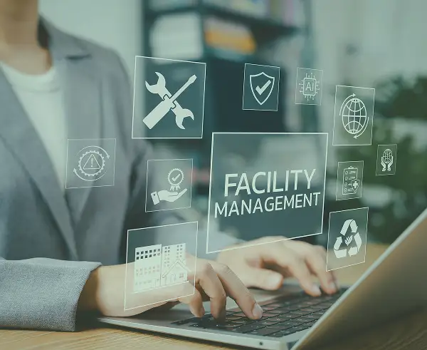 A woman typing on a laptop with icons related to facility management.