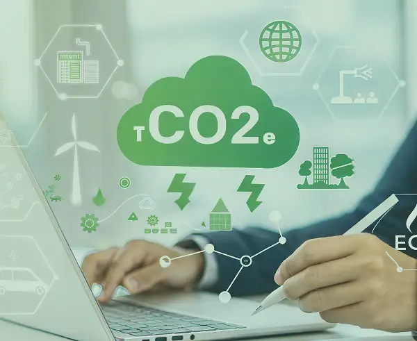 An image of a person on a laptop and icons related to Greenhouse gas omissions (GHG).