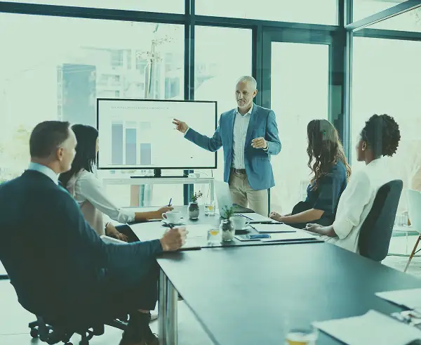 An executive giving a presentation in a board room.
